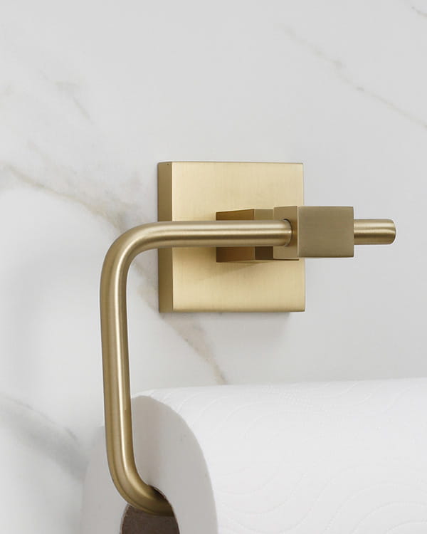 Bristan Square bathroom accessories, including a towel ring and toilet roll holder, in brushed brass