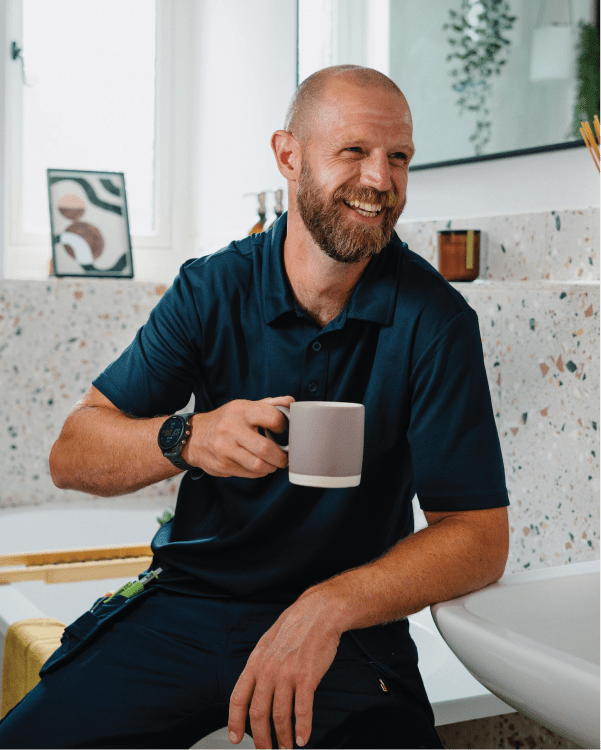 Installer with a Bristan Easyfit kitchen tap, showing how simple Top Fix installation is