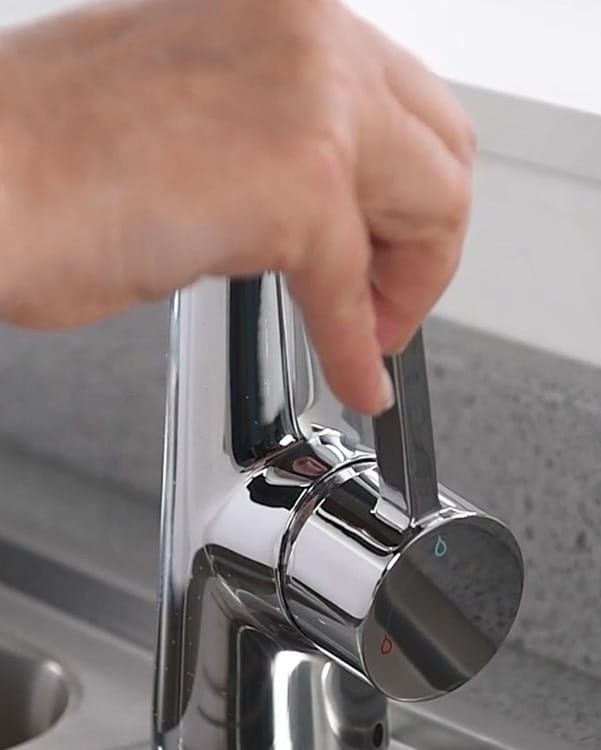 Close-up of a Bristan Thermaclick kitchen tap handle being adjusted to control water temperature