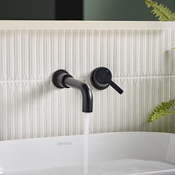 Bristan Alcove black wall-mounted basin mixer in a modern bathroom